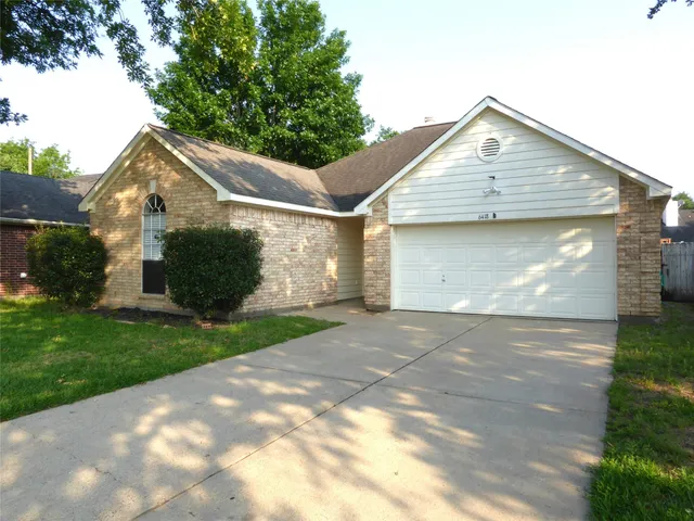 a front view of house with a garden