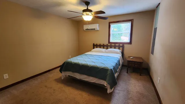 a bedroom with a bed and a chandelier