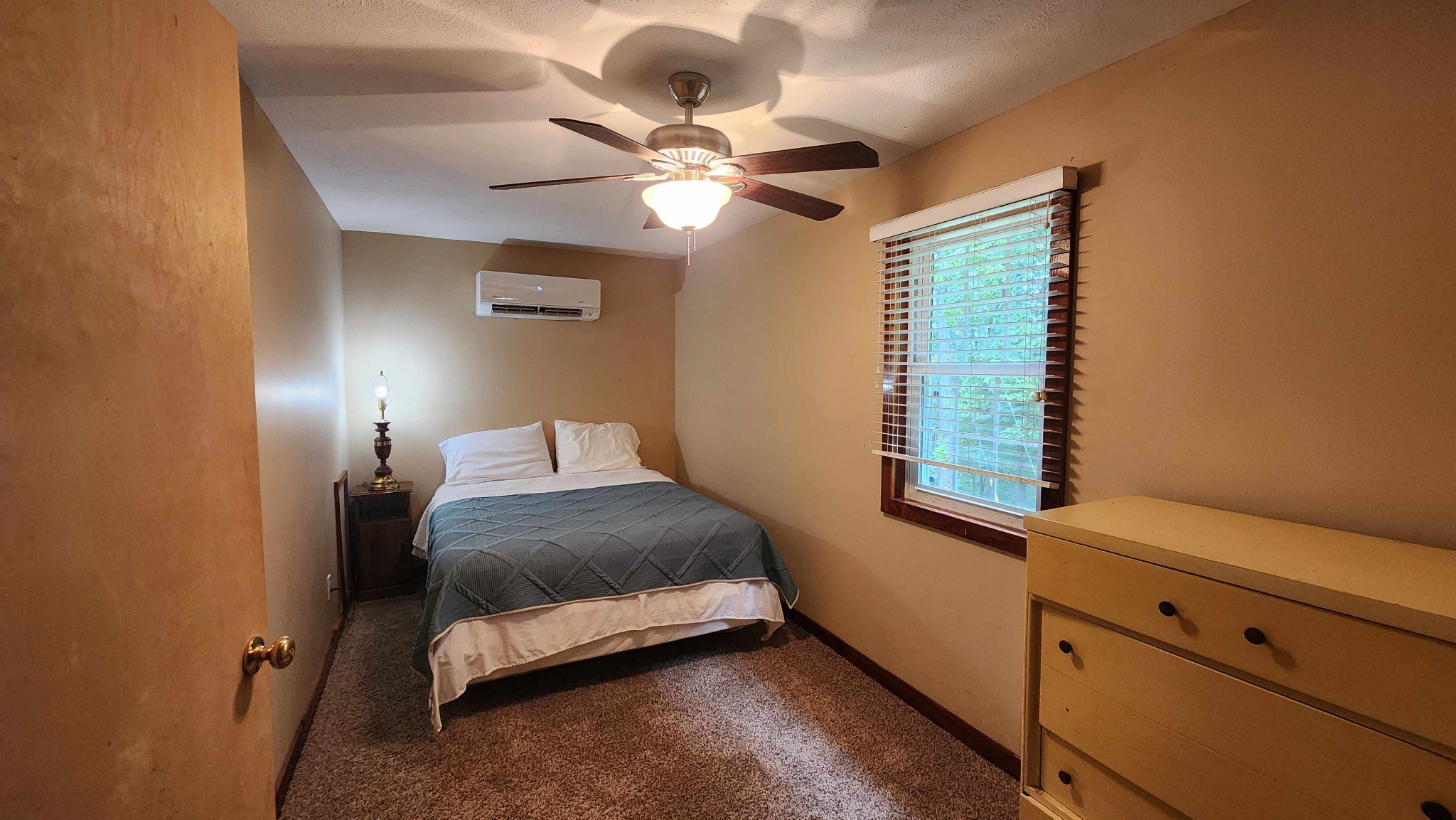 348 Bill Hunter Road Celina, TN 38551 - Photo 12 of 49 a bedroom with a bed and a chandelier