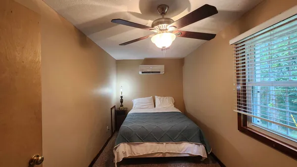 a bedroom with a bed and window