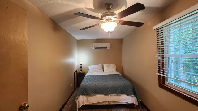 a bedroom with a bed and window