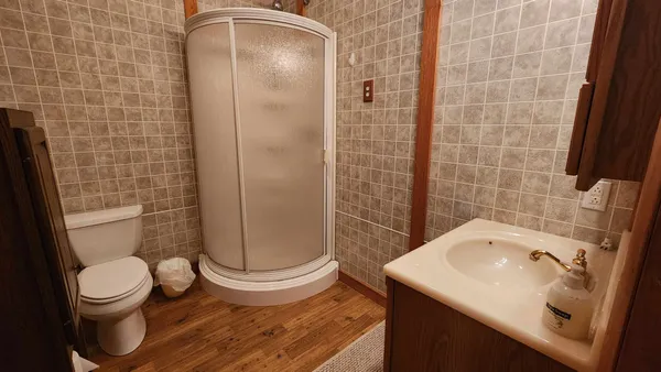 a bathroom with a sink toilet and shower