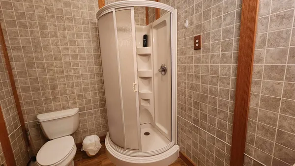 a white toilet sitting next to a bathroom sink