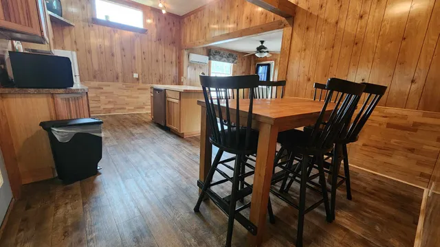 a view of a dining room with furniture and a flat screen tv