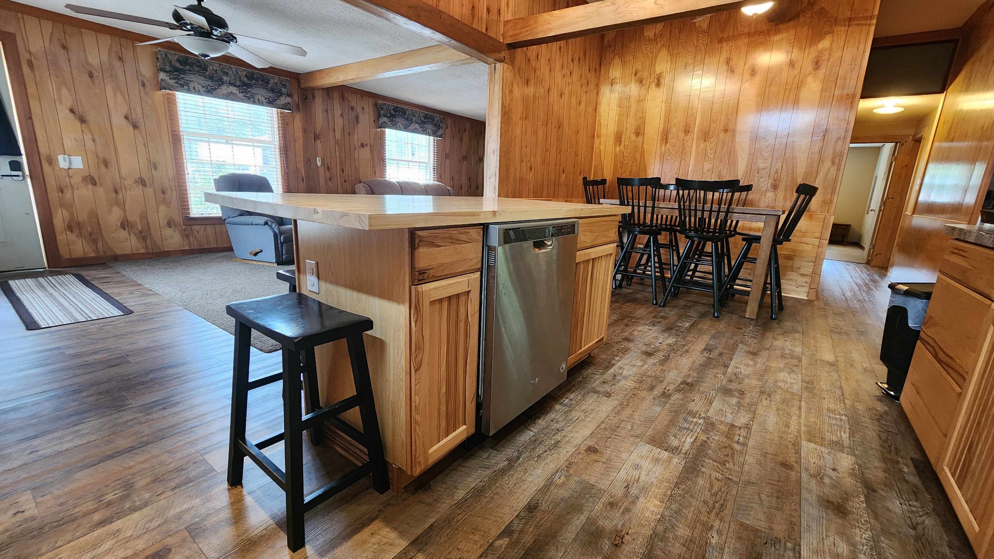 348 Bill Hunter Road Celina, TN 38551 - Photo 24 of 49 a dining hall with stainless steel appliances granite countertop a stove oven a dining table and chairs with wooden floor