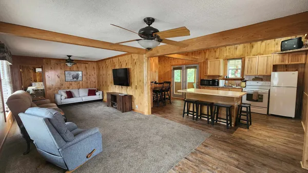 a living room with furniture and kitchen view