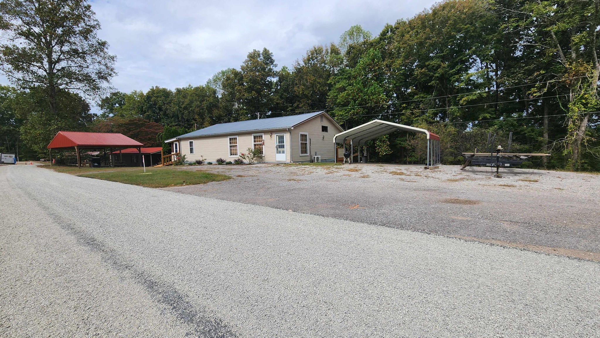 348 Bill Hunter Road Celina, TN 38551 - Photo 3 of 49 a front view of a house with a yard and garage