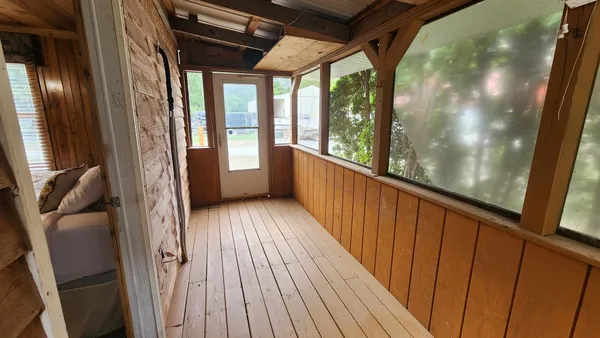 a view of balcony with wooden floor