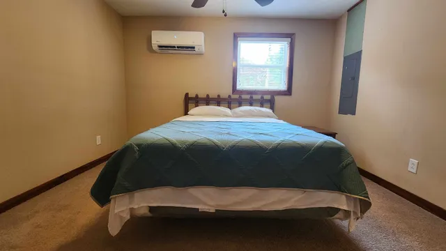 a bedroom with a bed and window