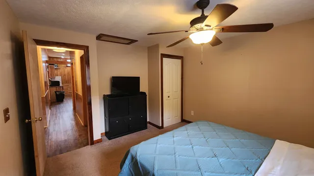 a bedroom with a bed and a chandelier