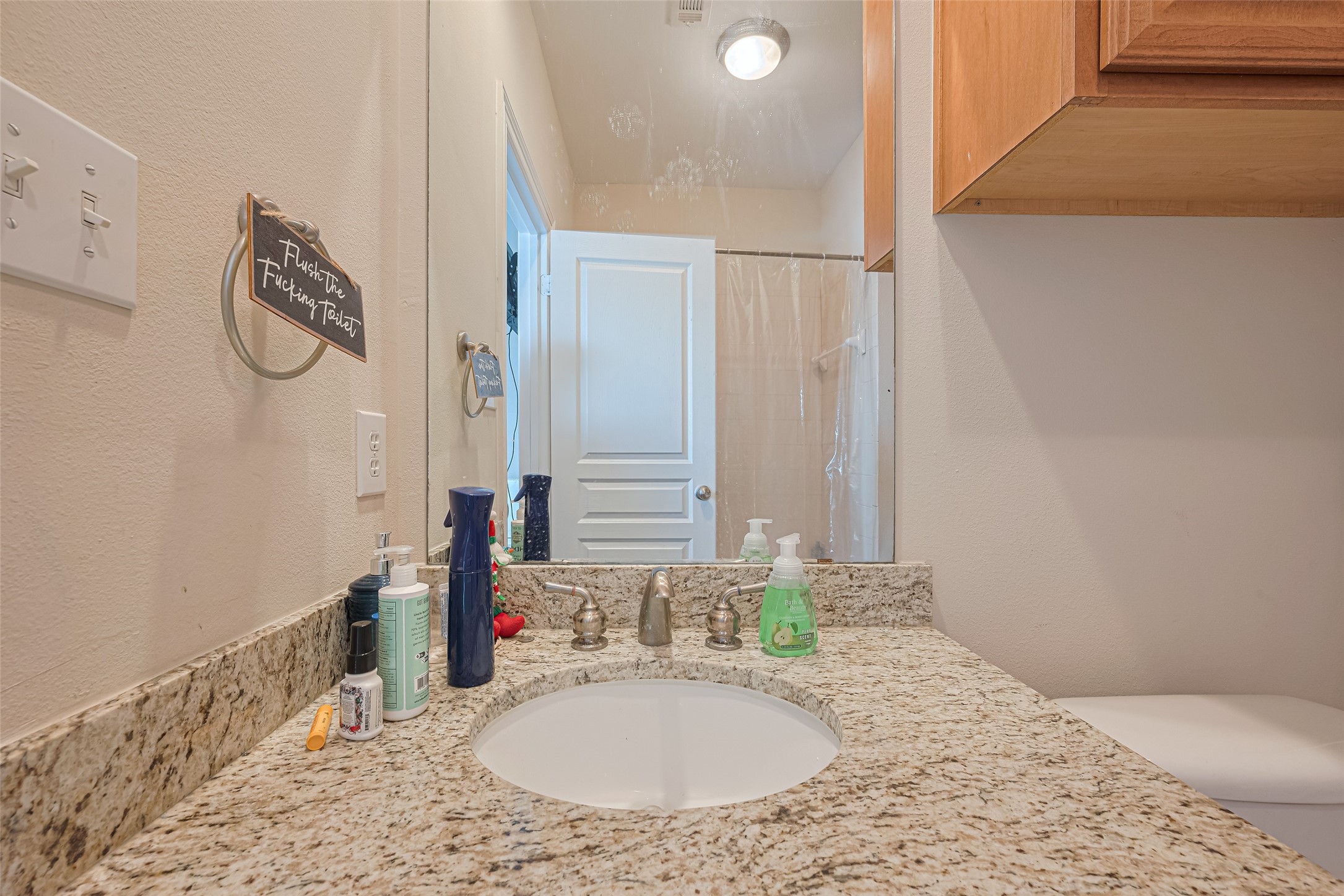 24 Versante Court Houston, TX 77070 - Photo 11 of 30 a bathroom with a granite countertop sink and a mirror