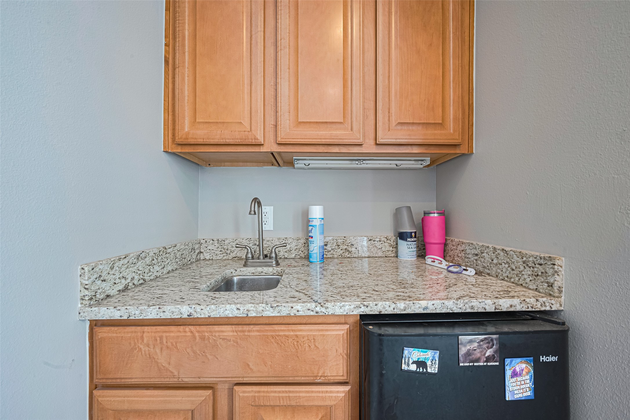24 Versante Court Houston, TX 77070 - Photo 13 of 30 a kitchen with granite countertop wooden cabinets and a sink