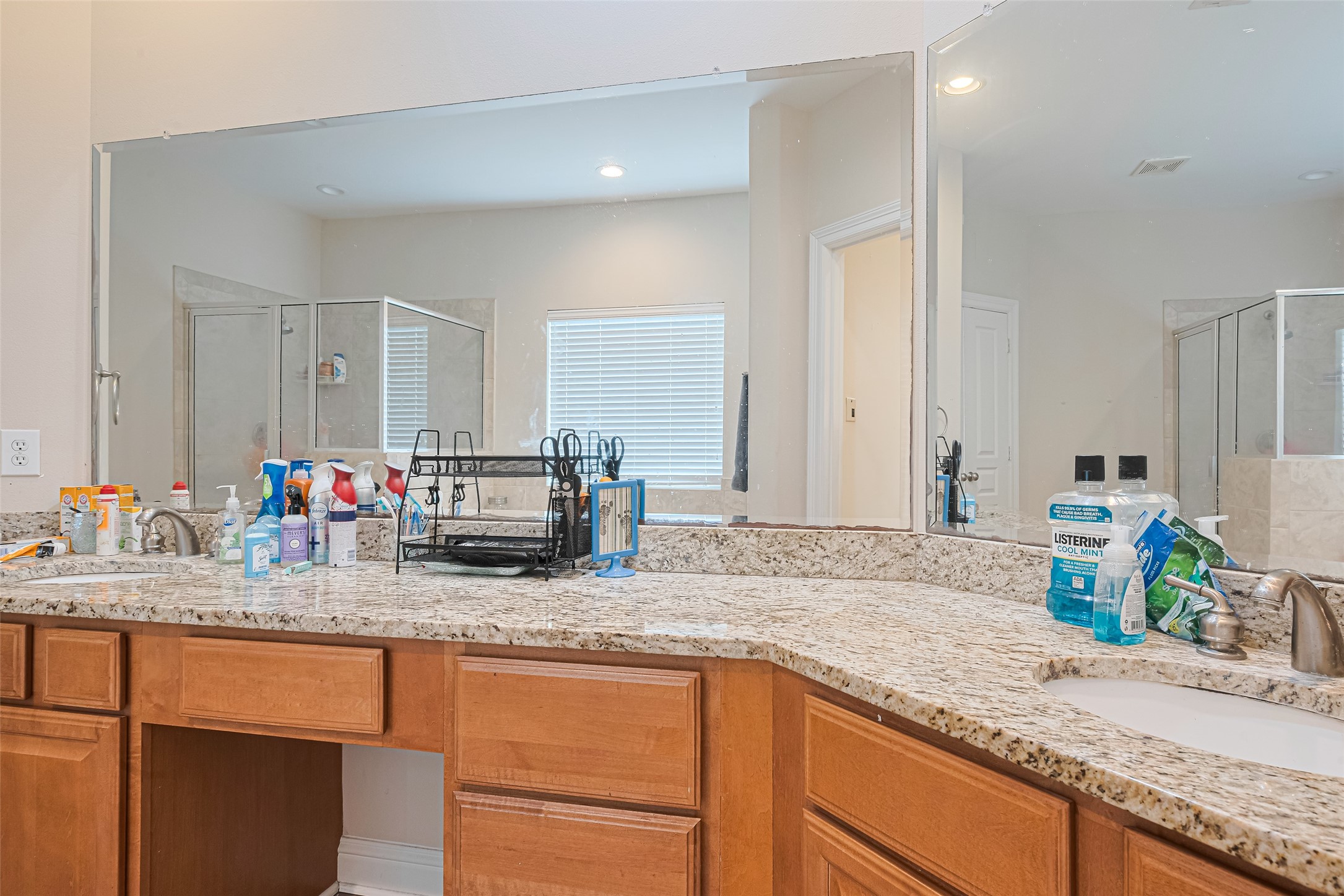 24 Versante Court Houston, TX 77070 - Photo 17 of 30 a kitchen with sink and a mirror