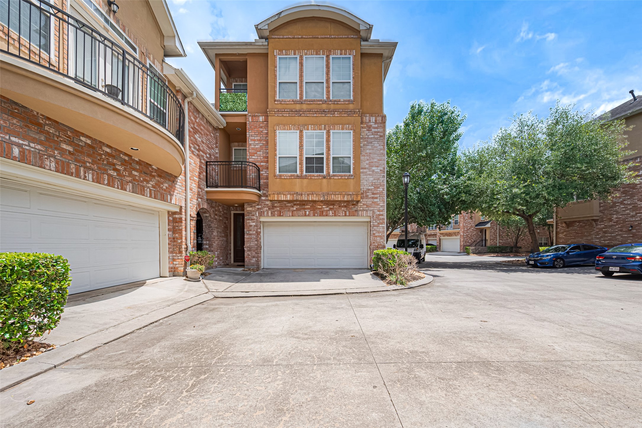 24 Versante Court Houston, TX 77070 - Photo 18 of 30 a view of a house with many windows and a car parked in front of it