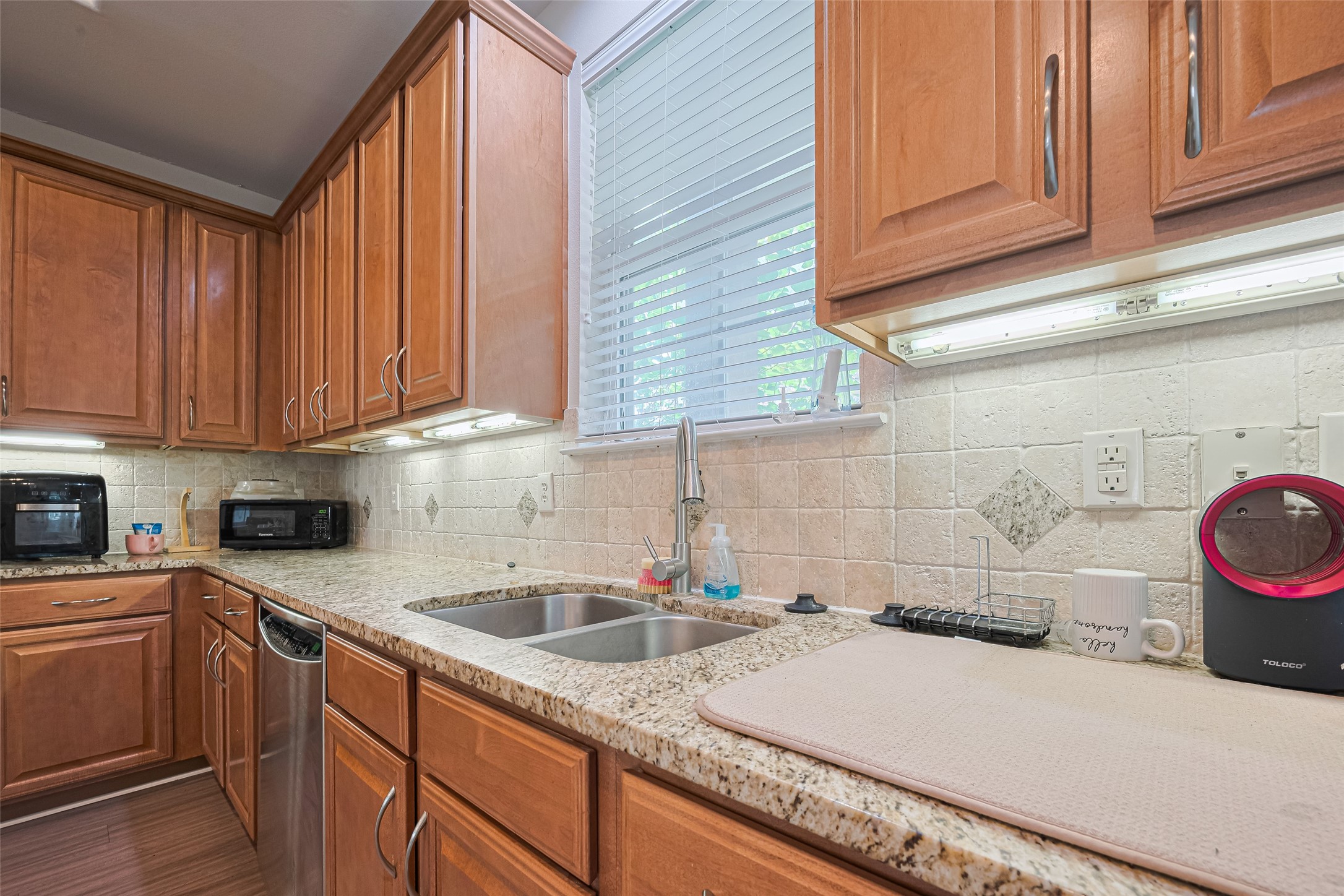 24 Versante Court Houston, TX 77070 - Photo 4 of 30 a kitchen with a sink and cabinets