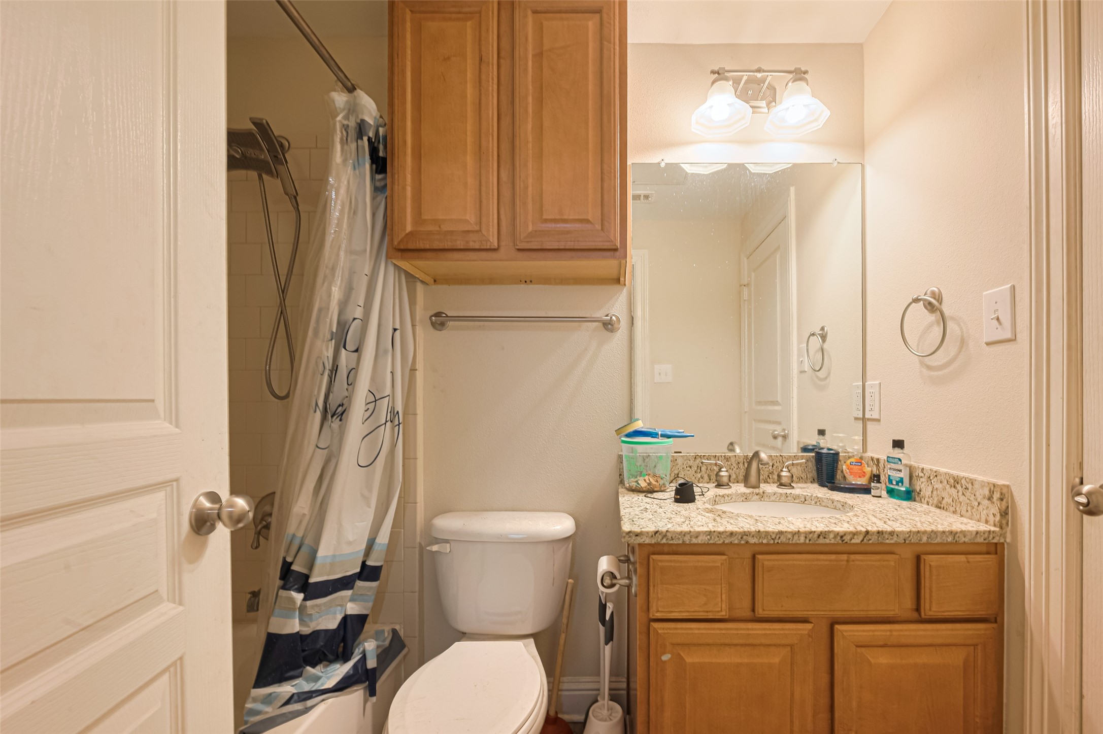 24 Versante Court Houston, TX 77070 - Photo 6 of 30 a bathroom with a granite countertop toilet sink and mirror