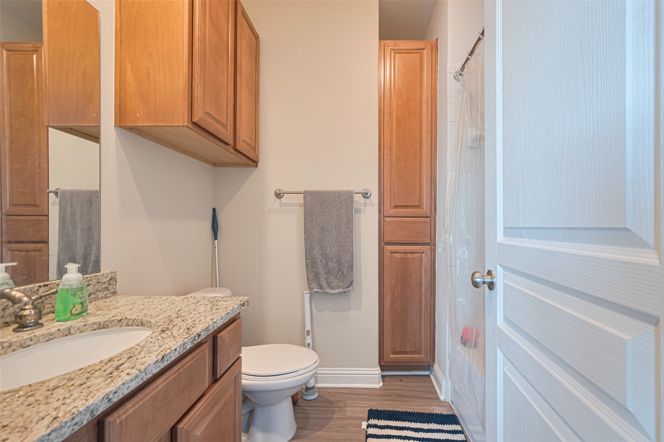 24 Versante Court Houston, TX 77070 - Photo 10 of 30 a bathroom with a granite countertop toilet and a sink
