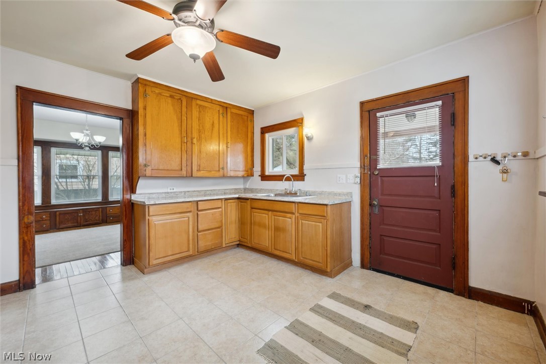 64 West Bagley Road Berea, OH 44017 - Photo 18 of 48 Kitchen with light counters, sink, and ceiling fan.