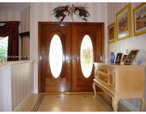 10500 Southwest 140th Road Miami, FL 33176 - Photo 3 of 16 a front view of a house with garden