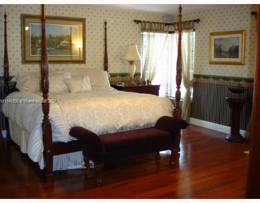 10500 Southwest 140th Road Miami, FL 33176 - Photo 6 of 16 a bedroom with a bed and a night stand