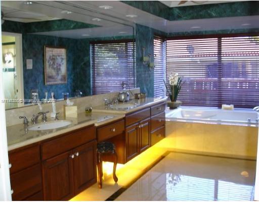 10500 Southwest 140th Road Miami, FL 33176 - Photo 7 of 16 a bathroom with a granite countertop sink and a bathtub