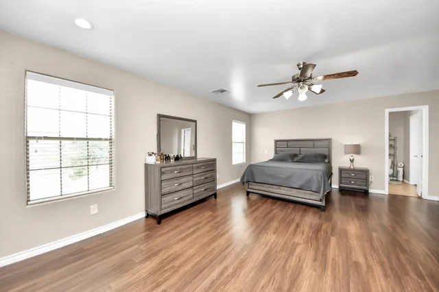 a bathroom with a granite countertop sink a toilet and a mirror