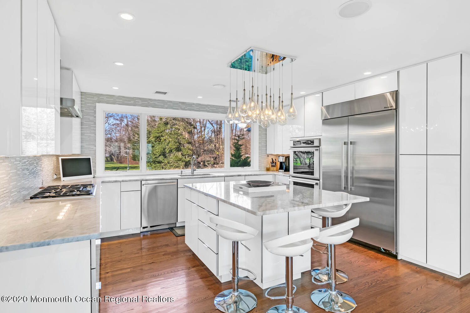 1 Horatius Way Rumson, NJ 07760 - Photo 5 of 24 a large white kitchen with a large window a sink and stainless steel appliances