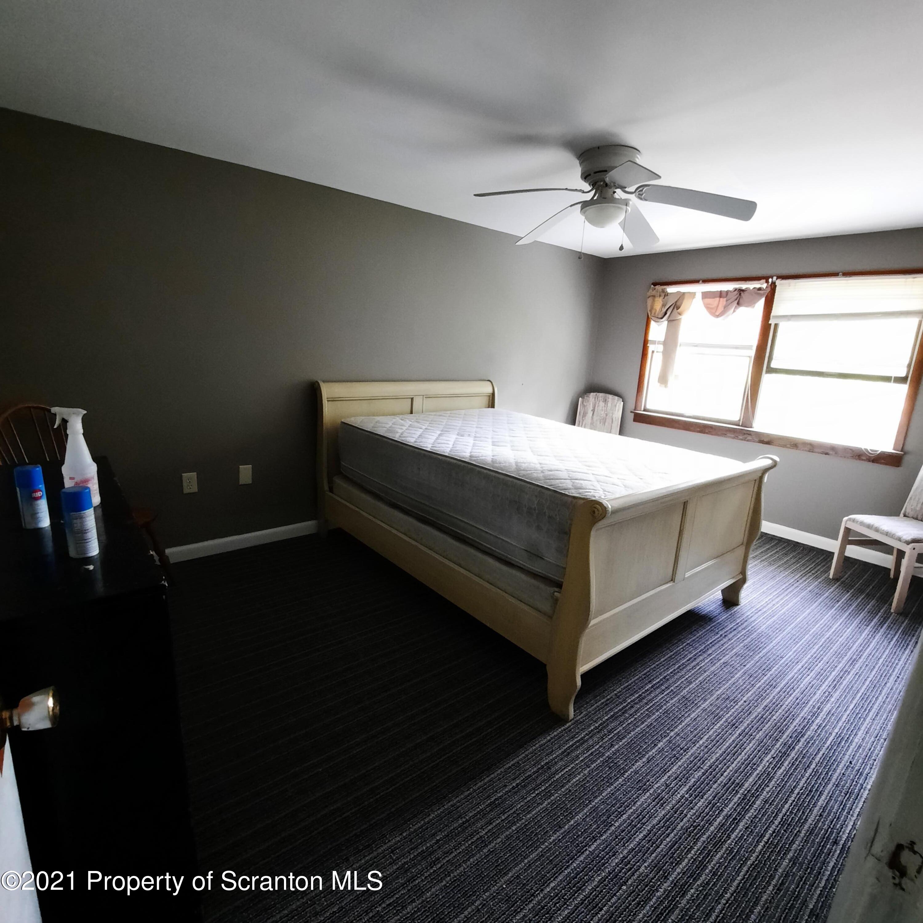 313 Marshal Squire Road Nicholson, PA 18446 - Photo 13 of 21 a bed sitting in a room next to a window