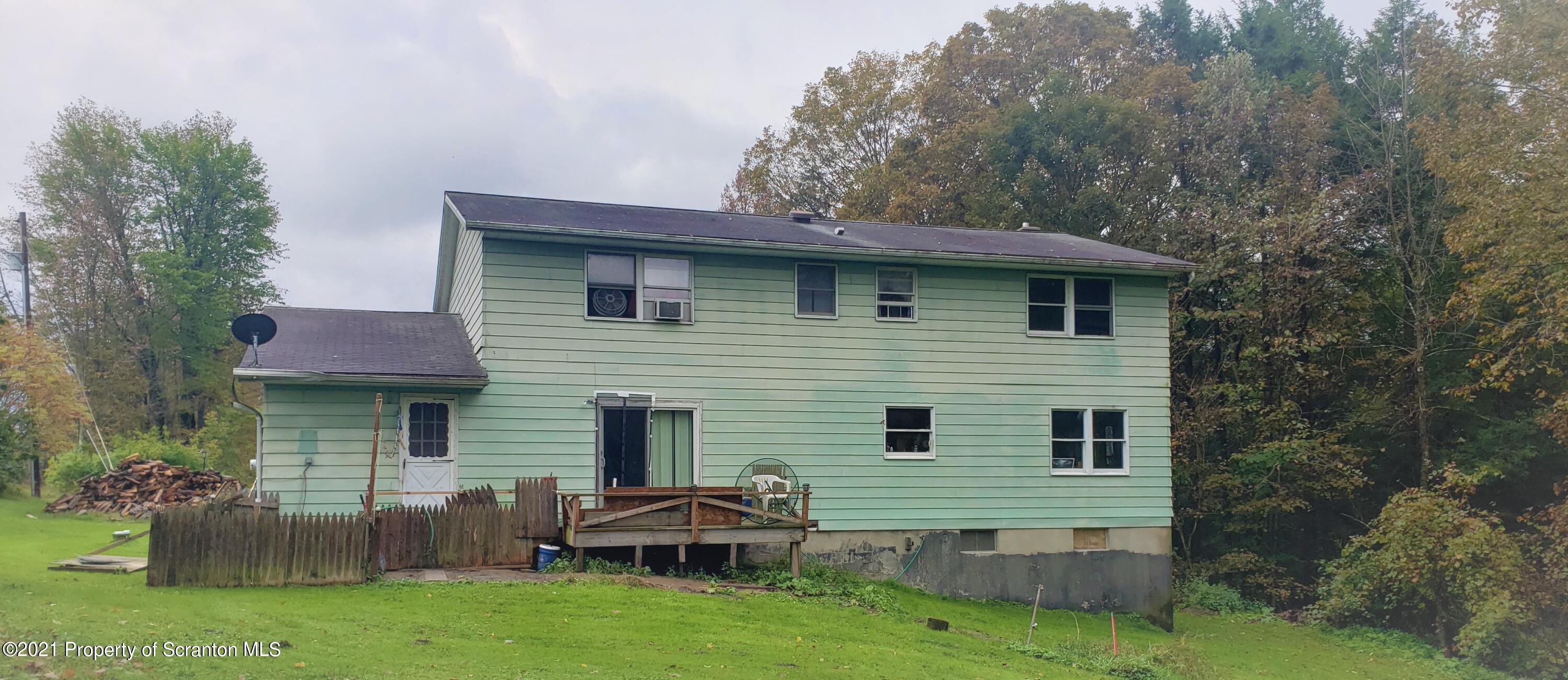 313 Marshal Squire Road Nicholson, PA 18446 - Photo 20 of 21 a front view of house with yard and outdoor seating