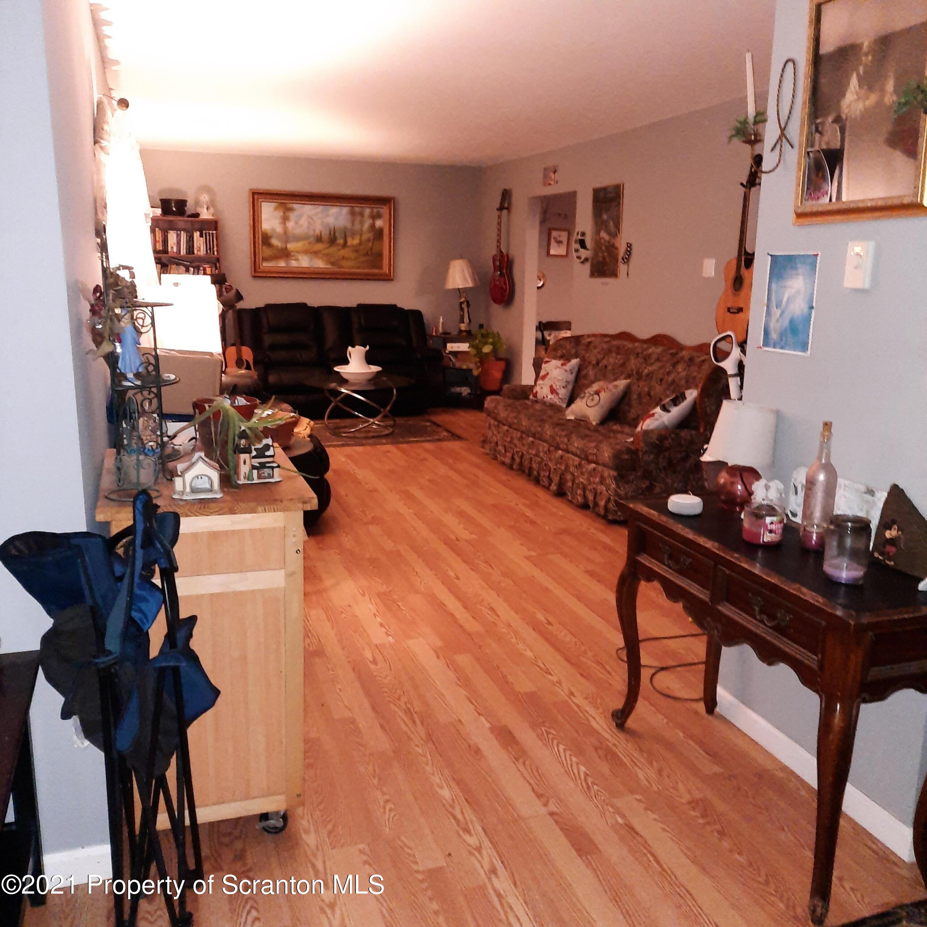313 Marshal Squire Road Nicholson, PA 18446 - Photo 7 of 21 a living room with furniture a piano and a flat screen tv