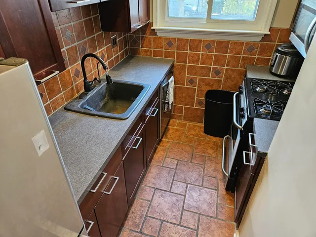 a view of a kitchen with a sink and cabinets
