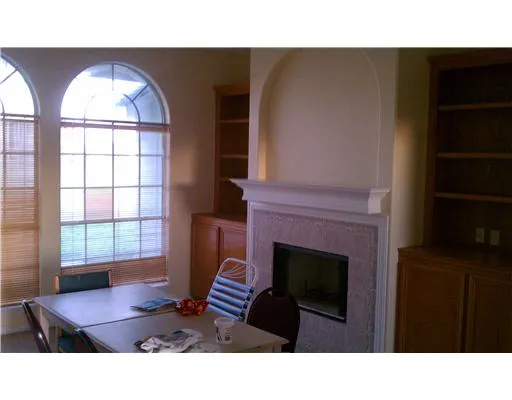 a living room with furniture a fireplace and a large window