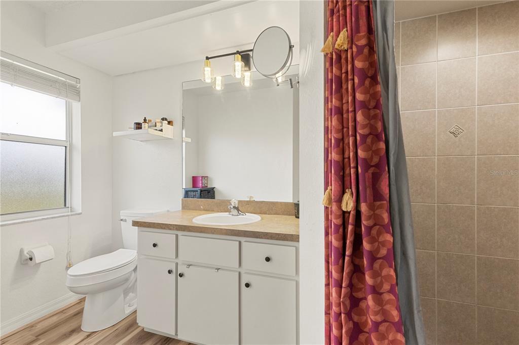 9917 Nelson Road Dade City, FL 33525 - Photo 27 of 40 a bathroom with a sink toilet and shower