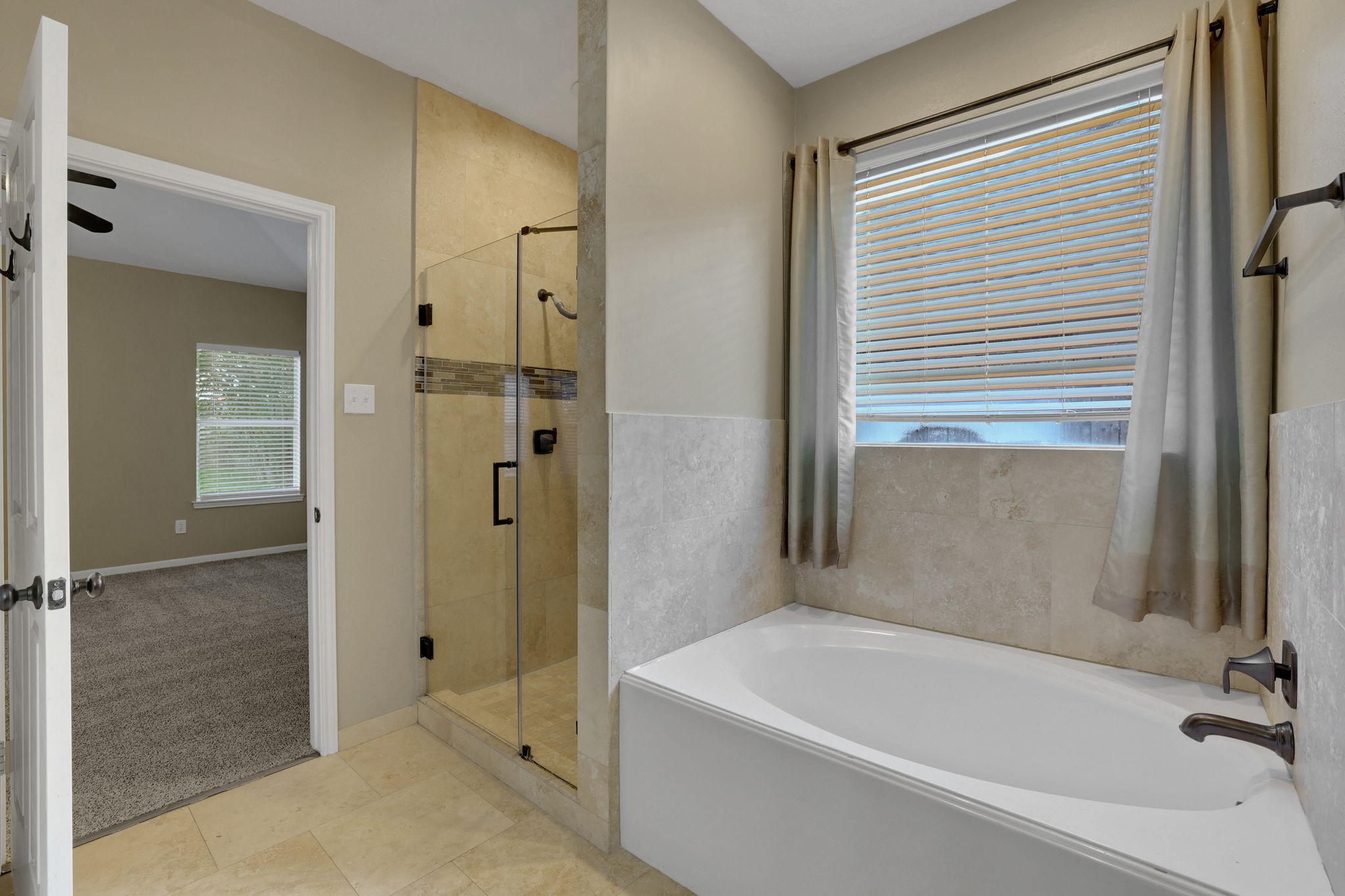 23207 Olive Ridge Court Katy, TX 77494 - Photo 23 of 46 a bathroom with a bathtub and a shower