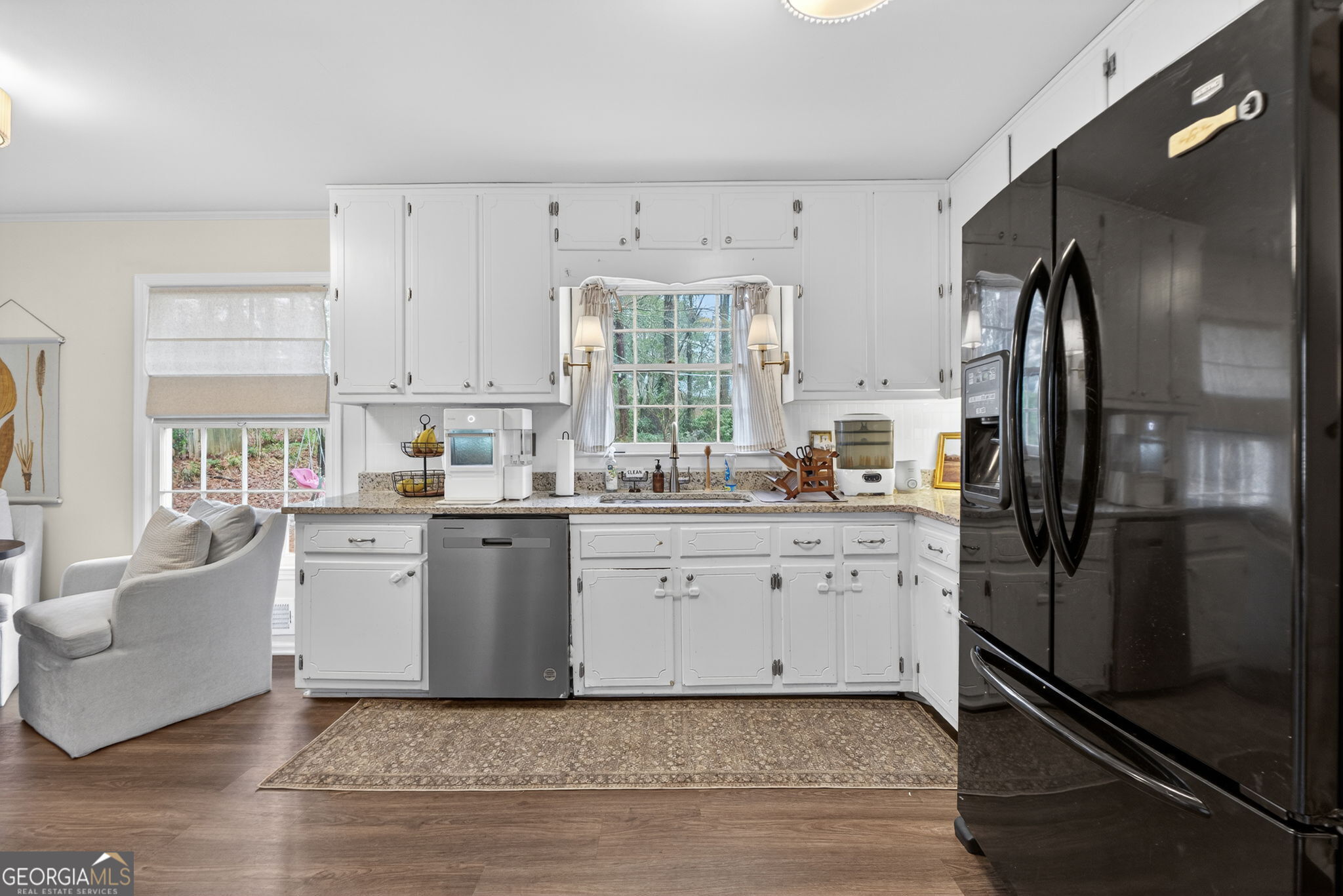 209 Laramie Road Griffin, GA 30224 - Photo 12 of 36 a kitchen with a refrigerator a sink cabinets and wooden floor