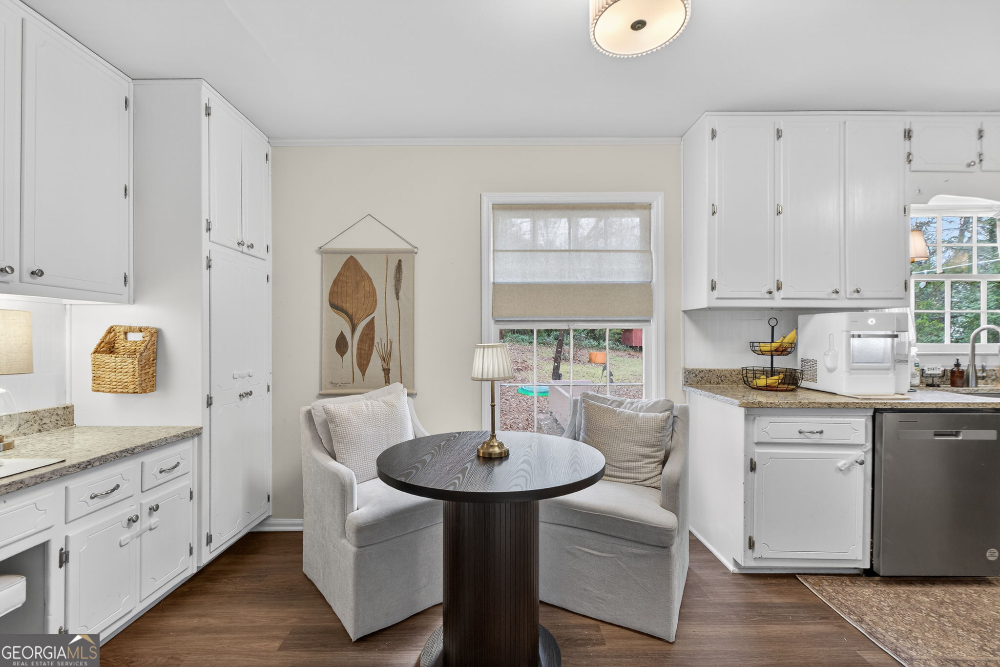 209 Laramie Road Griffin, GA 30224 - Photo 15 of 36 a kitchen with stainless steel appliances a sink a stove a dining table and chairs