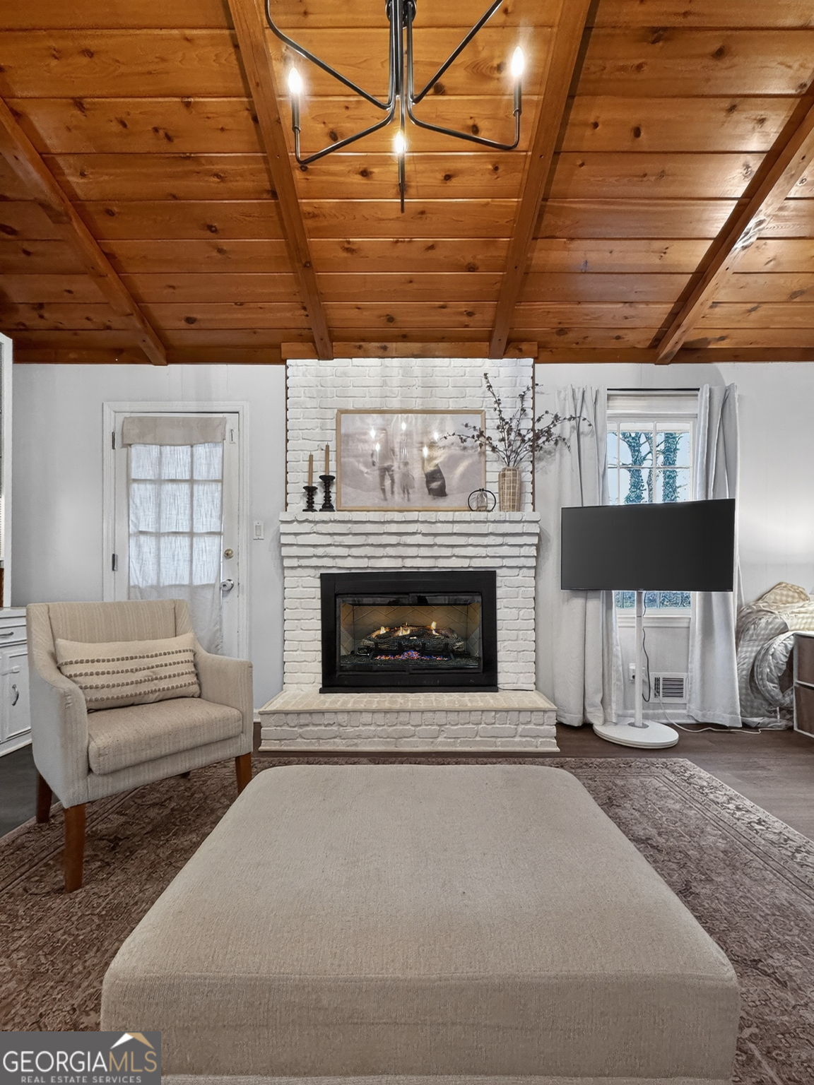 209 Laramie Road Griffin, GA 30224 - Photo 20 of 36 a living room with furniture a fireplace and a flat screen tv