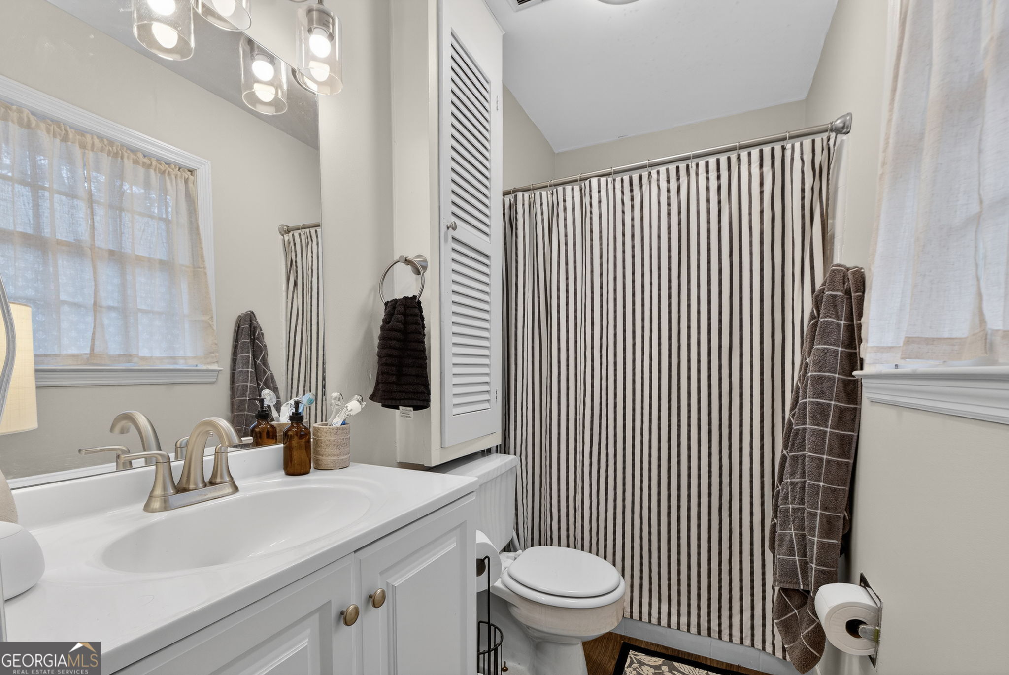 209 Laramie Road Griffin, GA 30224 - Photo 23 of 36 a bathroom with a sink toilet and shower