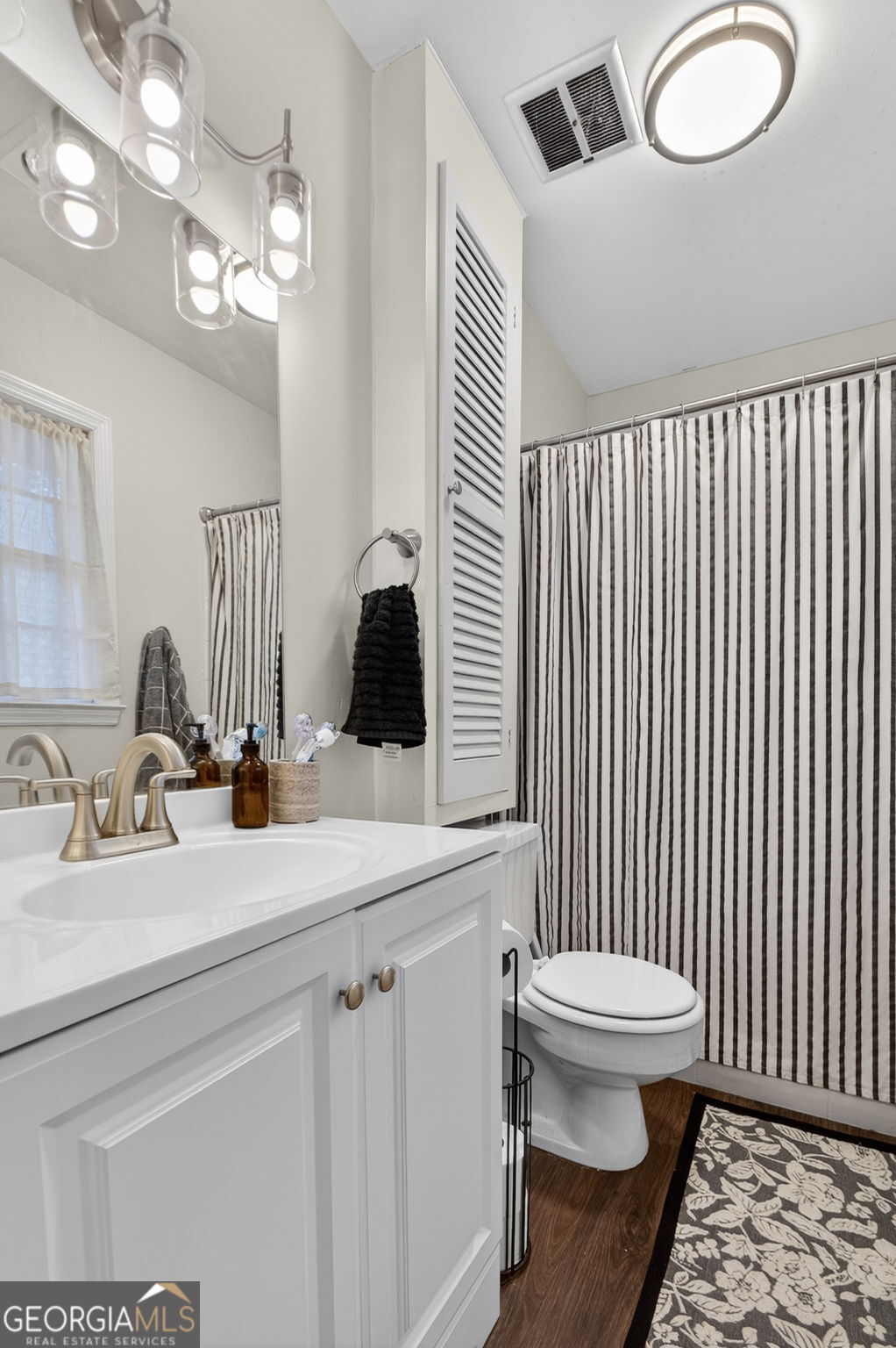 209 Laramie Road Griffin, GA 30224 - Photo 24 of 36 a bathroom with a sink a toilet and mirror