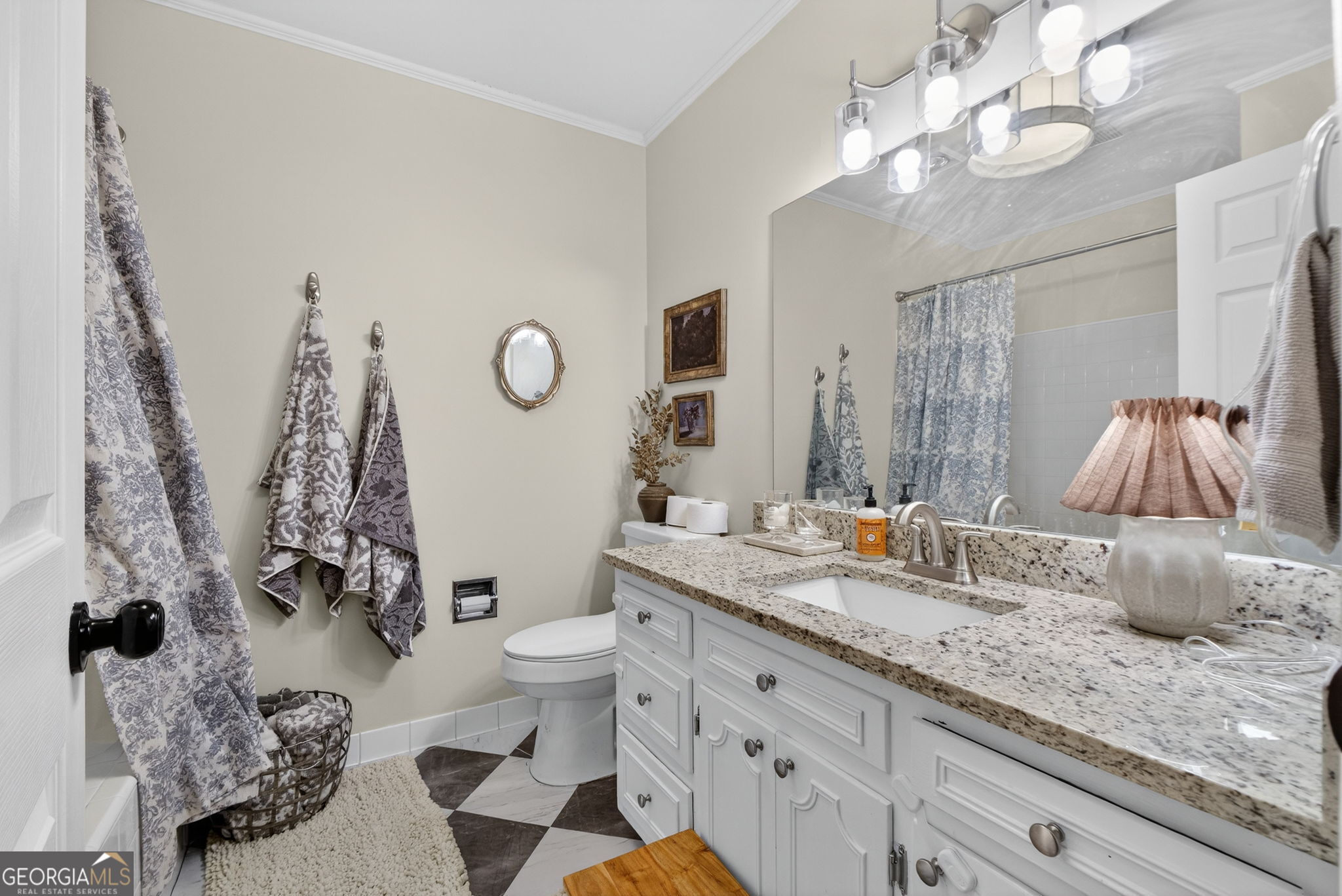 209 Laramie Road Griffin, GA 30224 - Photo 26 of 36 a bathroom with a granite countertop sink a toilet and a mirror