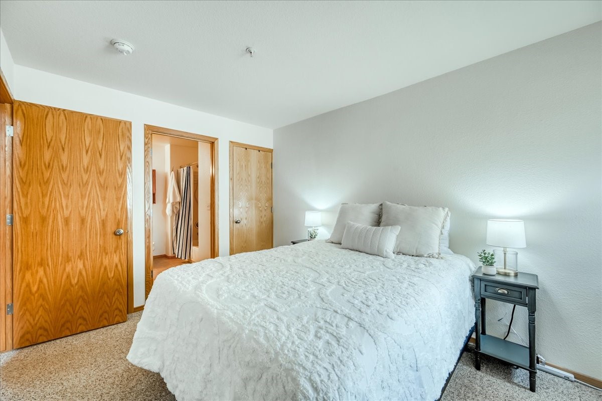 91399 Ryan Gulch Road, Unit B6 Silverthorne, CO 80498 - Photo 18 of 36 a bedroom with a bed and a table