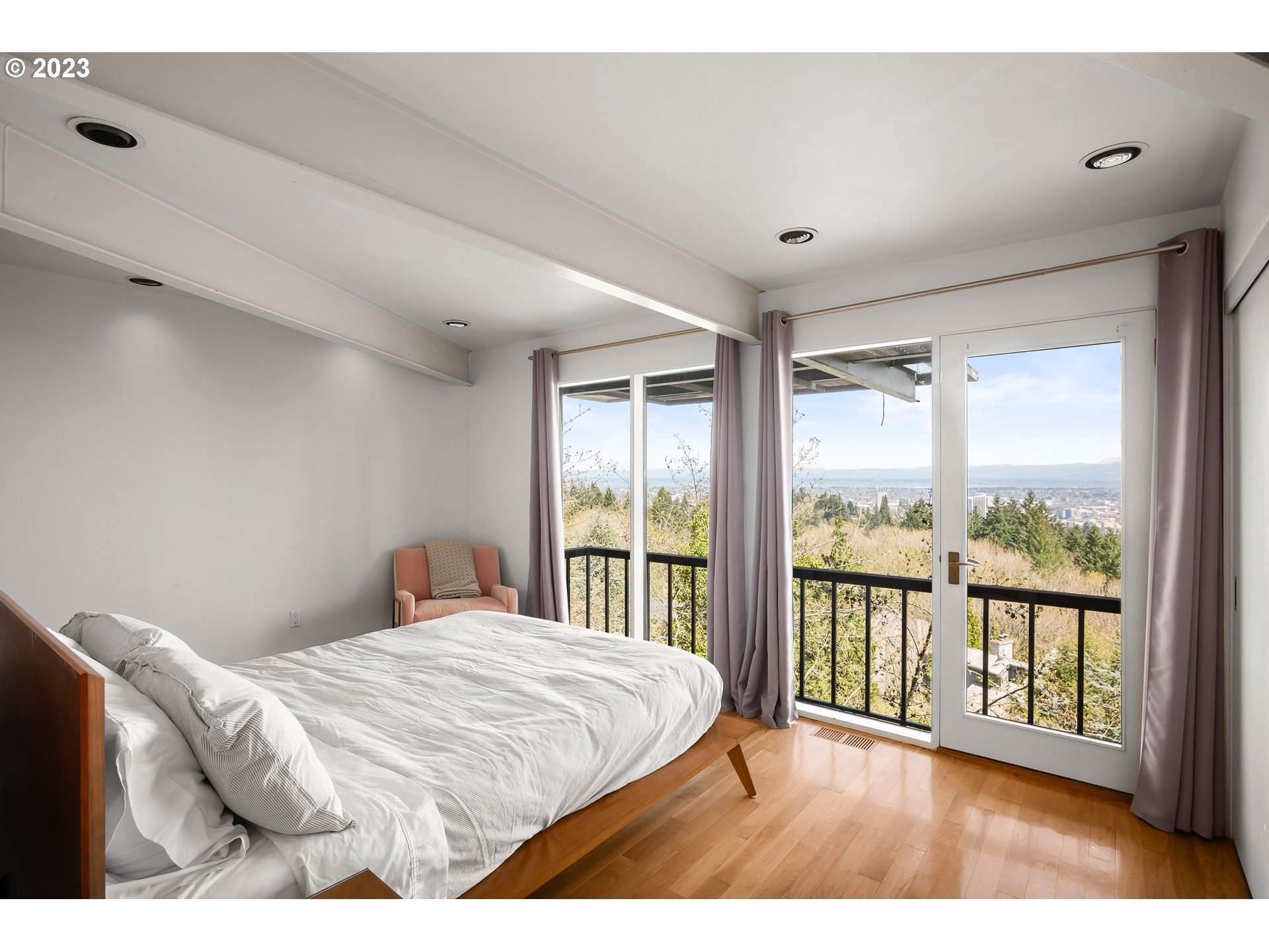 2880 Southwest Fairmount Boulevard Portland, OR 97239 - Photo 23 of 24 a bedroom with a large bed and a large window