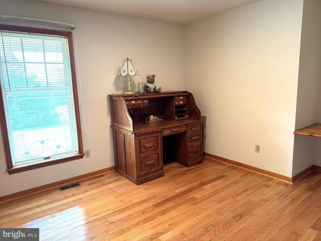 a room with a window and a mirror