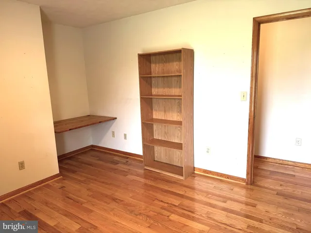 a view of an empty room and wooden floor
