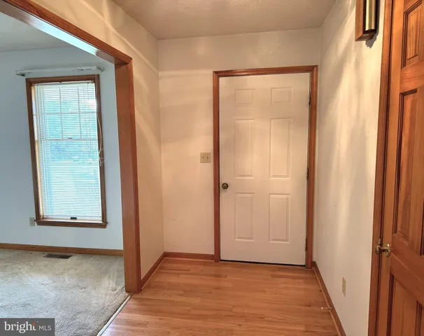 a view of an empty room with wooden door