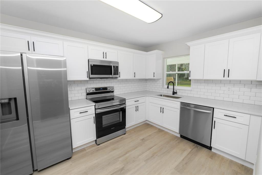 5105 Hayes Road Lakeland, FL 33811 - Photo 2 of 43 a kitchen with a refrigerator stove and microwave
