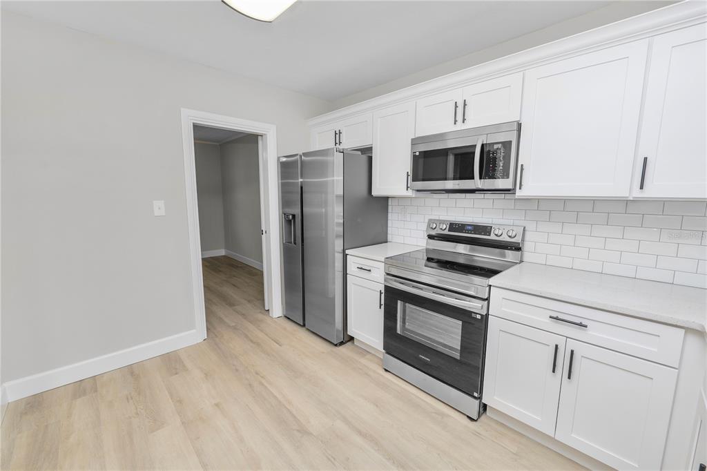 5105 Hayes Road Lakeland, FL 33811 - Photo 3 of 43 a kitchen with stainless steel appliances white cabinets and a stove