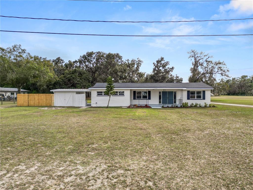 5105 Hayes Road Lakeland, FL 33811 - Photo 38 of 43 a front view of a house with a yard and fountain