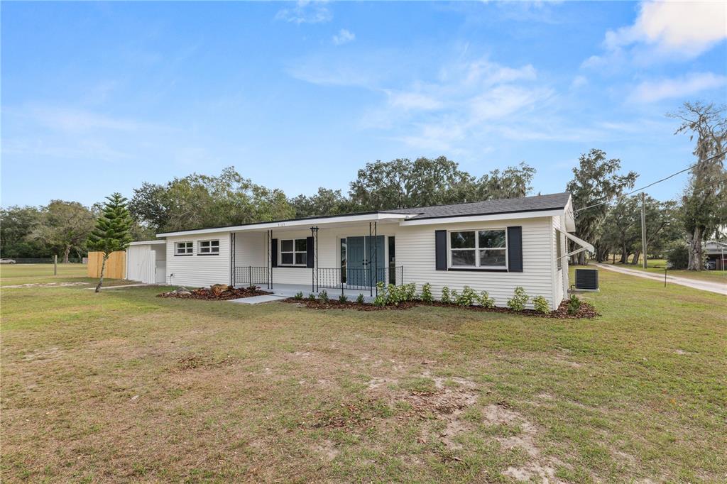 5105 Hayes Road Lakeland, FL 33811 - Photo 40 of 43 a view of a yard in front of a house with a garden and plants