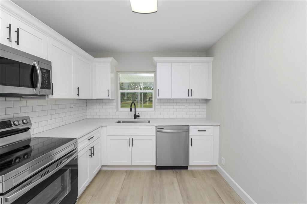 5105 Hayes Road Lakeland, FL 33811 - Photo 4 of 43 a kitchen with a sink stove and cabinets